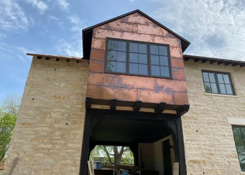 Copper metal panel facade on a stone building for Roof Repair in Waipahu