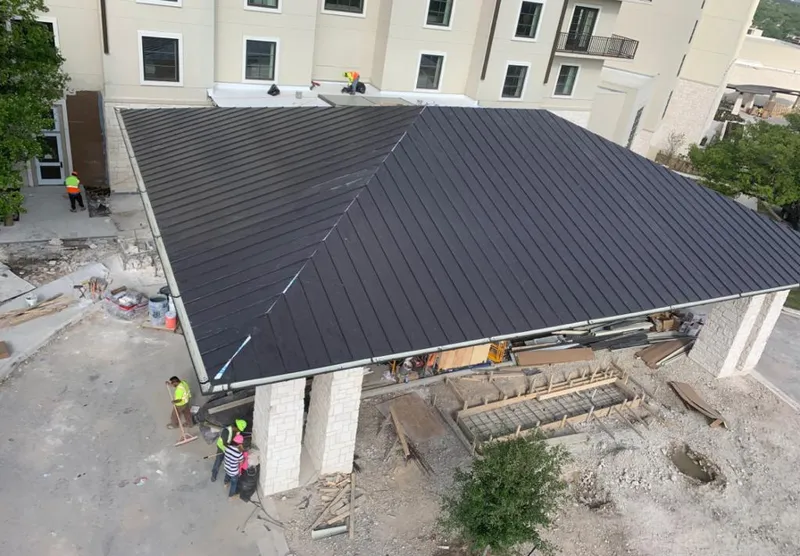 Metal roofing installation team working on a commercial building in Waipahu